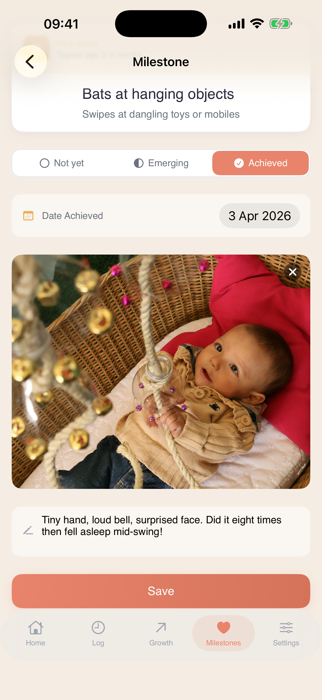 A milestone in TandemBaby. Emma's Fine Motor milestone "Bats at hanging objects" marked Achieved, with a photo and short note from the day it happened.